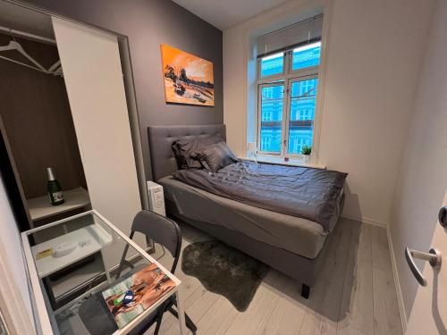 a small bedroom with a bed and a window at Private room in heart of Oslo Grunerløkka in Oslo