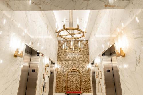 a hallway with a lobby with a chandelier at The Sutton Place Hotel Halifax in Halifax