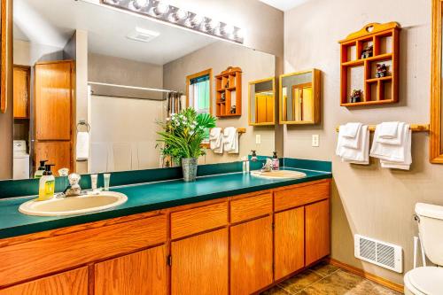 a bathroom with two sinks and a toilet at Eagle's Nest on Lake Sutherland in Port Angeles