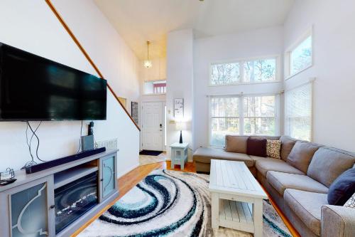 a living room with a couch and a flat screen tv at 5 Whitecap in Ocean Pines