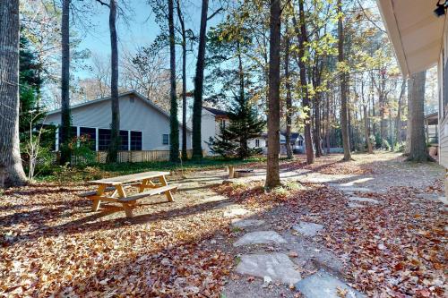 a picnic table in a park with trees and leaves at 5 Whitecap in Ocean Pines