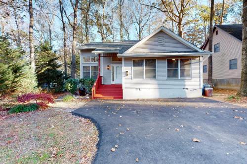 a white house with a red door and a driveway at 5 Whitecap in Ocean Pines