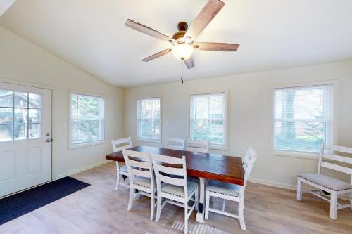 a dining room with a ceiling fan and a table and chairs at 5 Whitecap in Ocean Pines