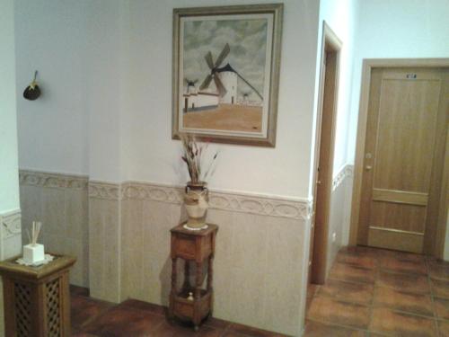 a room with a vase and a picture on the wall at Hostal Restaurante Ego's in Campo de Criptana