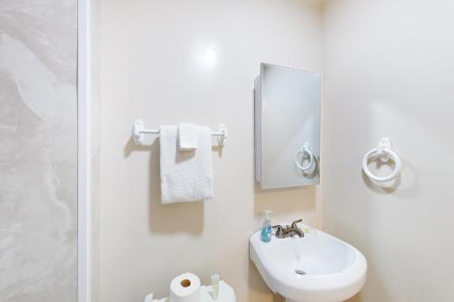 a white bathroom with a sink and a mirror at 5 Whitecap in Ocean Pines