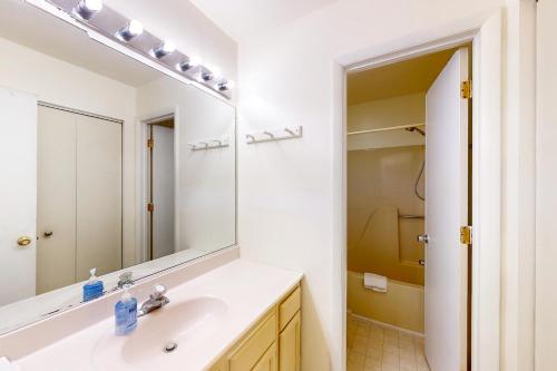 a bathroom with a sink and a large mirror at 5 Whitecap in Ocean Pines