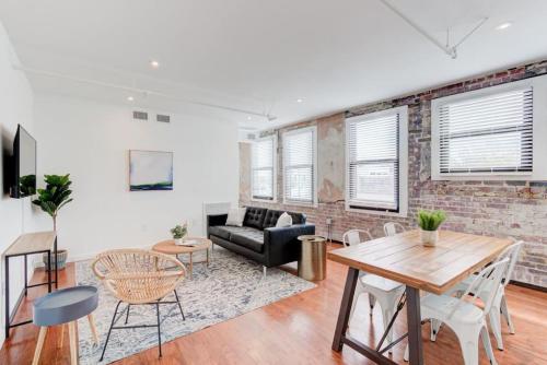 a living room with a brick wall at Downtown Loft Style Unit with ALL Modern Amenities in Memphis