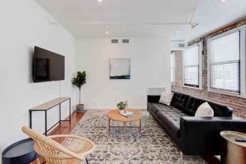 a living room with a couch and a table at Downtown Loft Style Unit with ALL Modern Amenities in Memphis