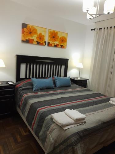 En eller flere senge i et værelse på Amplio y Centrico