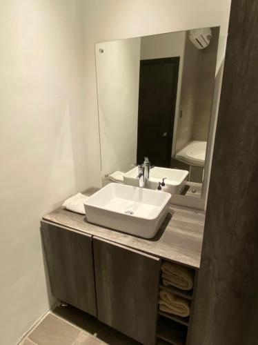 a bathroom with a sink and a mirror at Quinta del sol in Chihuahua