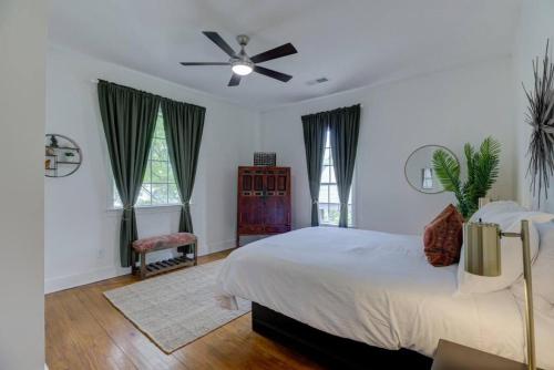 een slaapkamer met een bed en een plafondventilator bij Walk to Overton Square from your Historic Retreat in Memphis