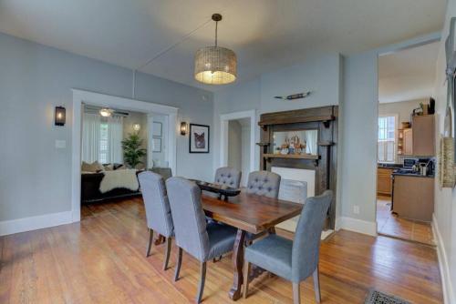a dining room with a wooden table and chairs at Walk to Overton Square from your Historic Retreat in Memphis