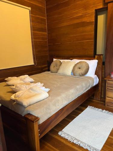 a bed with two pillows on it in a room at Cabañas Don Ramiro in Colonia Dos Ríos