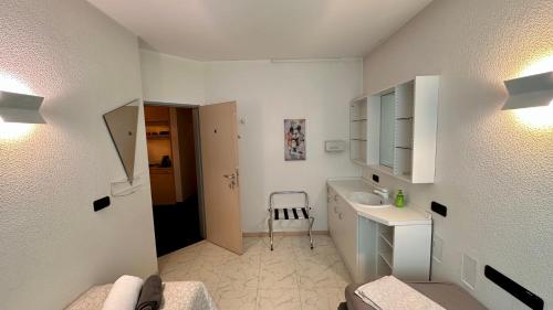 a white bathroom with a sink and a toilet at smart&beautiful HOSTEL in Nordkirchen