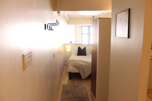 a small bedroom with a bed and a window at NEW! Lavish Studio Loft in Central Downtown SLC in Salt Lake City