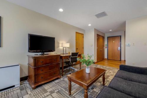 a living room with a flat screen tv and a couch at Best Western Plus Dubuque Hotel and Conference Center in Dubuque