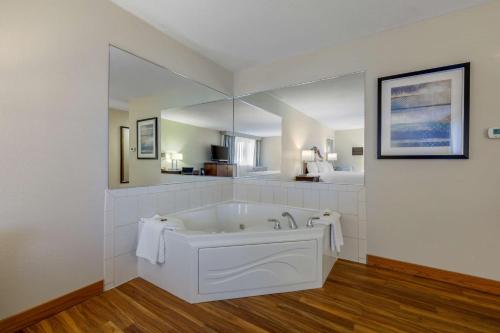 a large white bath tub in a room at Best Western Plus Dubuque Hotel and Conference Center in Dubuque
