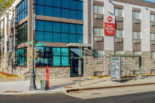 a building on a city street with a bus stop at Best Western Plus Brooklyn Bay Hotel in Brooklyn