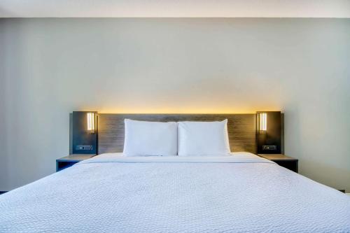 a large white bed with two pillows on it at Motel 6 Jeffersonville, IN in Jeffersonville