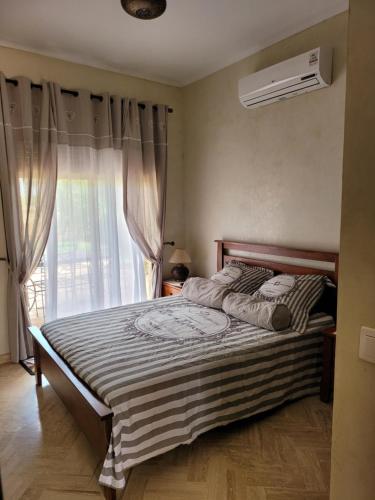 a bedroom with a large bed with a window at Atlas Golf Resort Marrakech in Marrakech