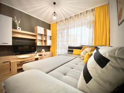 a living room with a bed and a couch at Art Apartment for 4 People Free Parking & Wifi in Stara Zagora