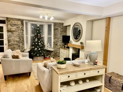 a living room with a christmas tree and a table at Pottery Gate, Bowness-on-Windermere in Bowness-on-Windermere