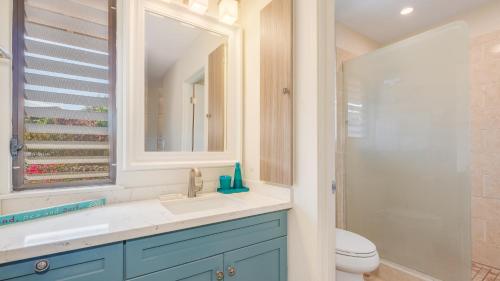 a bathroom with a sink and a toilet and a mirror at Wailea Ekahi 21F in Wailea