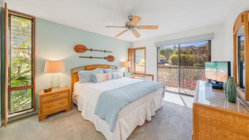 a bedroom with a bed and a large window at Wailea Ekahi 21F in Wailea