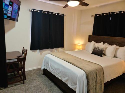 a bedroom with a large bed with a ceiling fan at 070A Cozy Studio with Kitchen near South Rim Sleeps 4 in Valle