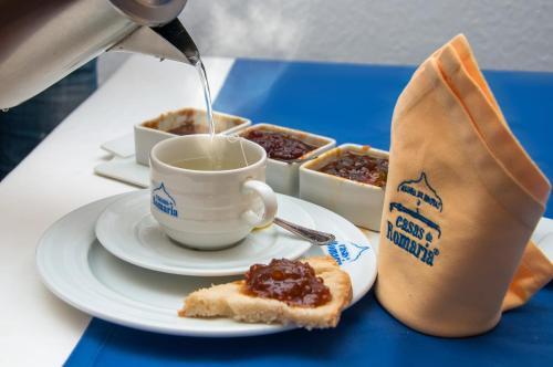 a cup of coffee and a plate of food at Casas De Romaria in Brotas
