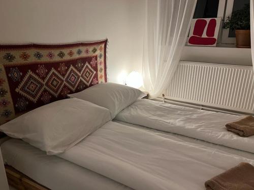 a white bed with a lamp next to a window at Rusiborek Slow in Murzynowo Kościelne