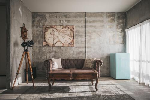 a living room with a couch and a camera at Yanbaru Hostel in Kunigami