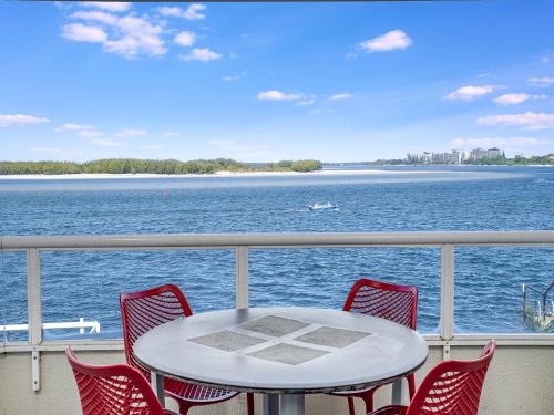 a table and chairs on a balcony overlooking the water at Pumicestone Quays by Luxury Escapes Caloundra in Caloundra