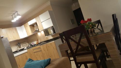 a kitchen with a table and a chair and a counter at Sheraton Ocean 202 - Without Pool access in Cairo