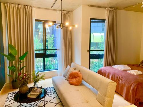 a living room with a couch and a bed at Ken's Place四谷 in Tokyo