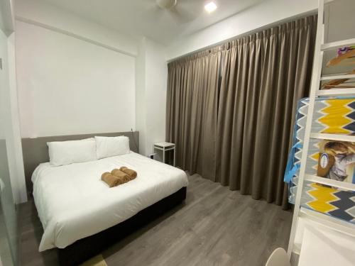 a bedroom with a bed with two teddy bears on it at 4-7 Pax Genting View Resort Kempas Residence -Free Wifi, Netflix And Free Parking in Genting Highlands