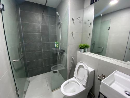 a bathroom with a shower and a toilet and a sink at 4-7 Pax Genting View Resort Kempas Residence -Free Wifi, Netflix And Free Parking in Genting Highlands