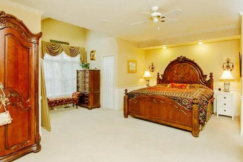 a large bedroom with a bed and a ceiling fan at Luxury Vacation Estate in Pottstown
