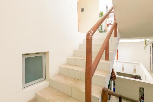 a staircase in a house with a window at Hotel las flores in Santa Cruz Huatulco