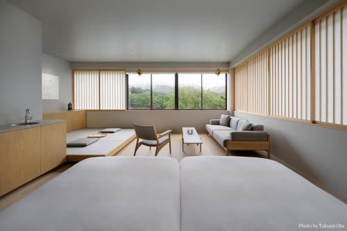 奈良市にあるMIROKU 奈良 by THE SHARE HOTELSのベッドルーム1室(ベッド1台付)、リビングルームが備わります。