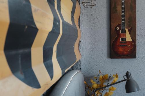 a guitar hanging on a wall next to a lamp at Viña Calabria in Valle de Guadalupe