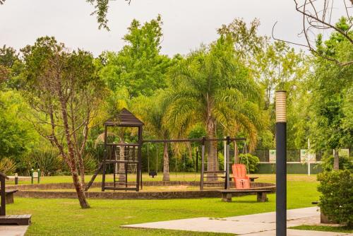 a park with a playground with a swing at Solares de la Bahía in Tigre