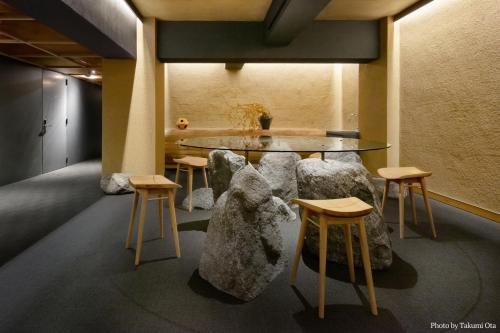 奈良市にあるMIROKU 奈良 by THE SHARE HOTELSのテーブル、椅子、テーブルが備わる客室です。