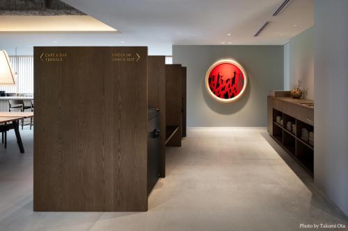 a room with a refrigerator and a red painting on the wall at MIROKU NARA by THE SHARE HOTELS in Nara