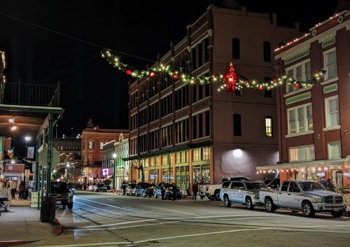 a city street at night with christmas lights at The 1890 Freeman House in Galveston
