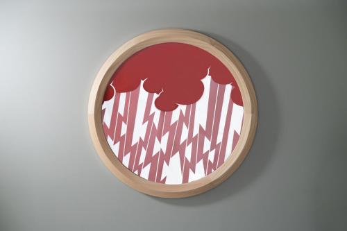 a red and white wall clock on a white wall at MIROKU NARA by THE SHARE HOTELS in Nara