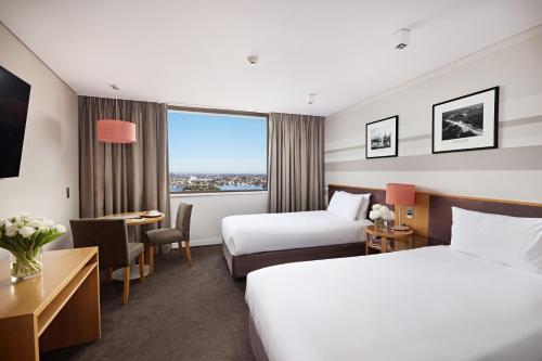 a hotel room with two beds and a window at View Sydney in Sydney