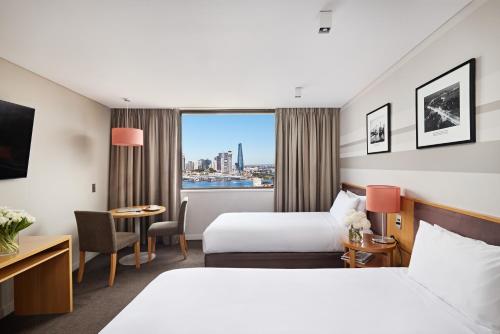 a hotel room with two beds and a window at View Sydney in Sydney