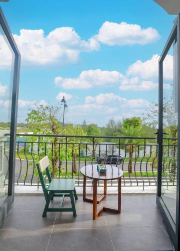 a balcony with a table and a chair at The Sol House in Phu Quoc
