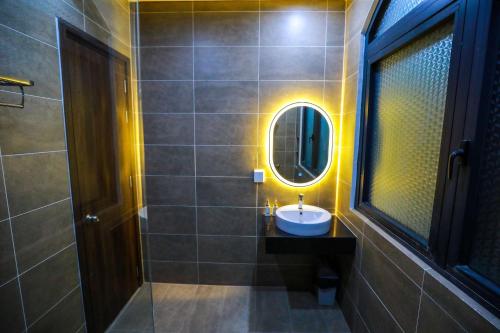 a bathroom with a sink and a mirror at The Sol House in Phu Quoc